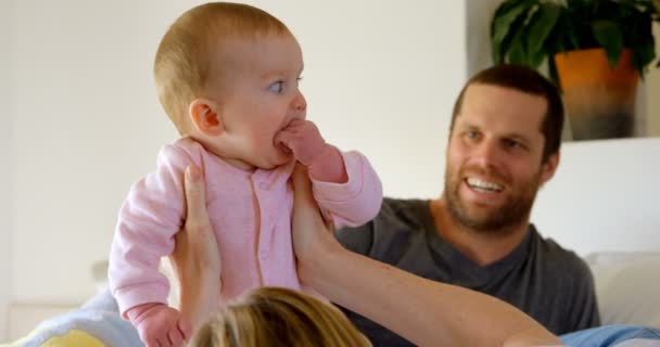 自宅の寝室で赤ちゃんと楽しんで幸せな白人の親 白人母持株赤ちゃん — ストック動画