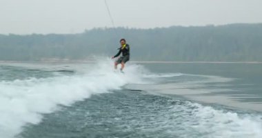 Önden Görünümü üzerinde şehir nehre wakeboard yapan beyaz delikanlı. Wakeboard ip 4 k tutan binici