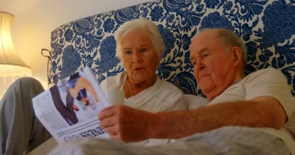 Elölnézet Kaukázusi Idősebb Pár Olvasás Híreket Papír Ágyon Hálószobában Kényelmes — Stock videók