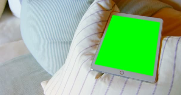 自宅クッションでデジタル タブレットのクローズ アップ デジタル タブレット で緑色の画面 — ストック動画