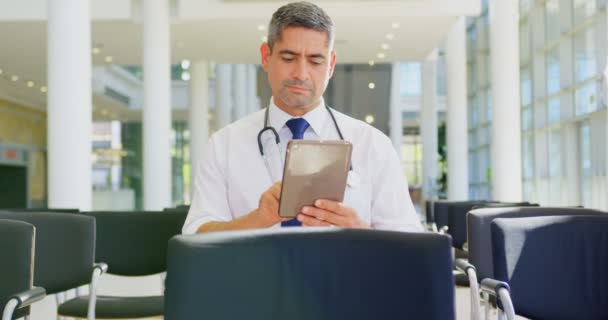 Front View Caucasian Male Doctor Holding Digital Tablet While Sitting — Stock Video