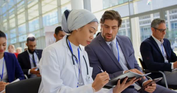 Side View Female Doctor Discussing Digital Tablet While Sitting Business — Stock Video