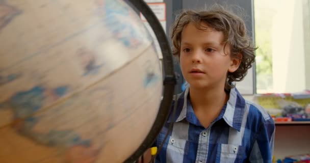 Front View Caucasian Schoolboy Studying Globe Desk Classroom School She — Stock Video