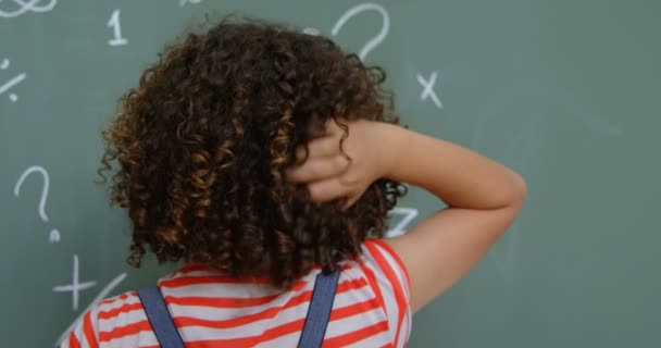 Rear View Mixed Race Schoolgirl Scratching Her Head Classroom School — Stock Video