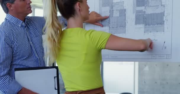 Caucasian Male Female Architects Discussing Blueprint Office Pointing Looking Blueprint — Stock Video