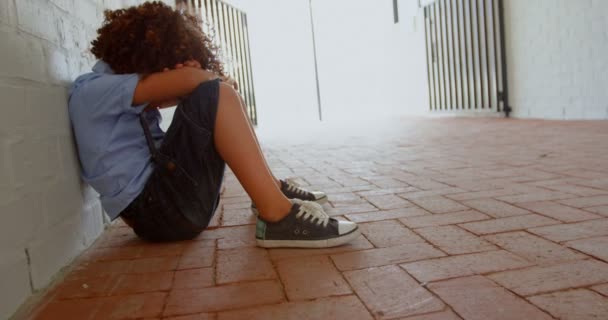 Side View Mixed Race Schoolboy Sitting Alone Floor Corridor School — Stock Video