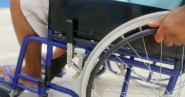 Engelli aktif üst düzey Afro-Amerikan adamın yakın çekim gezinti üzerinde tekerlekli sandalye hareket. Tekerlekli sandalye 4k tekerleğiitiyor