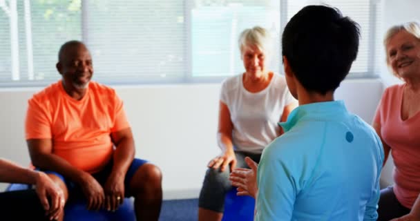 Vista Trasera Del Entrenador Femenino Entrenando Personas Mayores Gimnasio Están — Vídeos de Stock