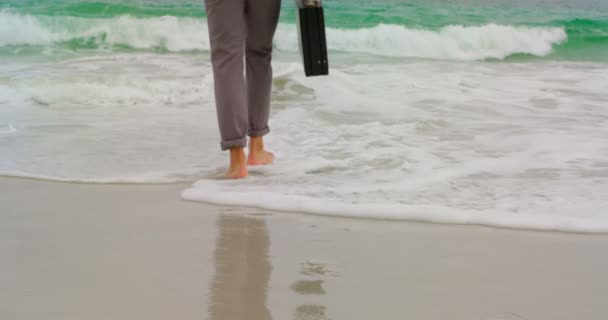 Ein Geschäftsmann Läuft Barfuß Mit Aktentasche Strand Entlang Meereswellen Hintergrund — Stockvideo