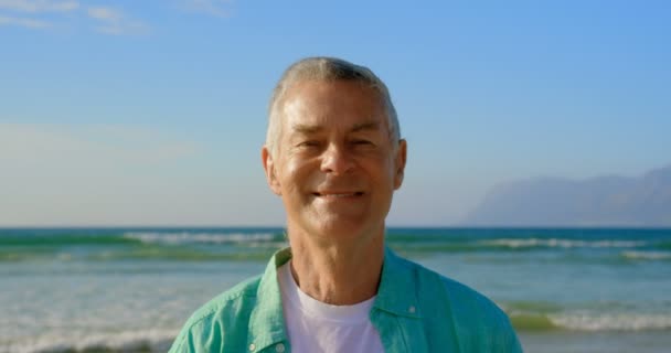 Front View Active Senior Caucasian Man Standing Beach Smiling Looking — Stock Video