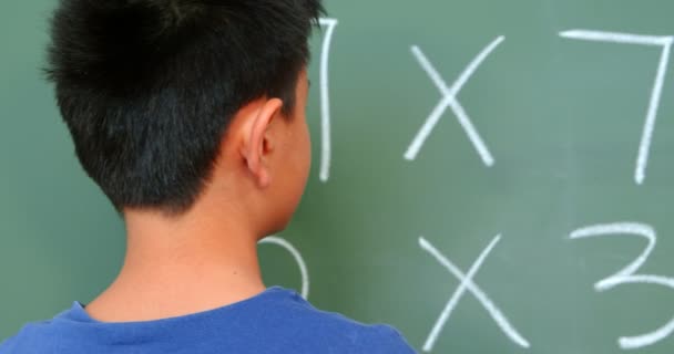 Bakifrån Asiatiska Skolpojke Lösa Matematiska Problem Svarta Tavlan Klassrummet Skolan — Stockvideo