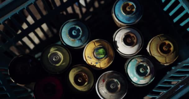 Gros plan des aérosols disposés dans le panier par une journée ensoleillée. Aérosols multicolores 4k 