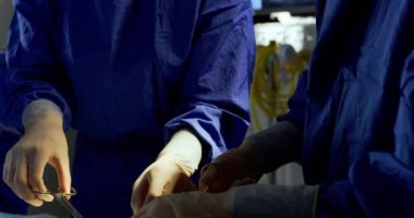 Hastanede operasyon salonunda ameliyat yapan çok ırklı cerrahların ön görünümü. Birlikte 4k faaliyet gösteriyorlar