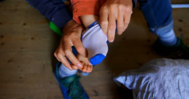 Low Section Caucasian Father Helping His Son Put Socks Bedroom — Stock Video