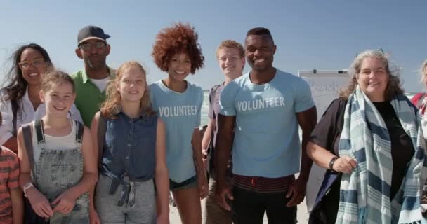 Retrato Diversos Voluntarios Parados Juntos Playa Bajo Sol Están Sonriendo — Vídeos de Stock