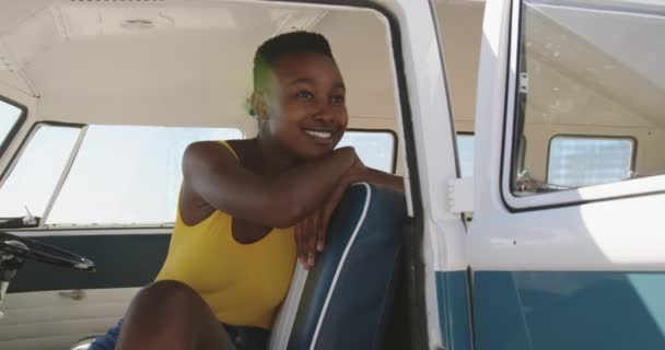 Close up of a young African American woman relaxing in the front seat leaning of a camper van. Summer Road Trip in Camper Van to the beach with friends 4k — Stock Footage Close Young African American Woman Relaxing Front Seat Leaning Camper Stock Video