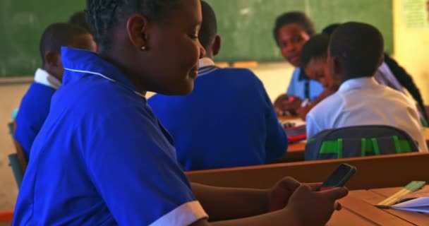 Side View Close Young African Schoolgirl Sitting Her Desk Using — Stockvideo