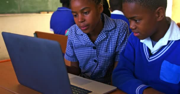 Front View Close Young African Schoolboy Schoolgirl Sitting Desk Using — Αρχείο Βίντεο