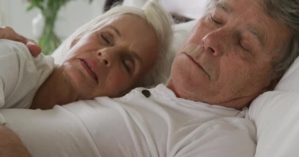一緒に寝ている ベッドの中の先輩白人女性と男性のサイドビュークローズアップ — ストック動画