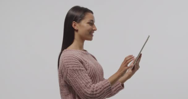 侧视特写一个年轻的白种妇女站在使用平板电脑 说话和微笑 — 图库视频影像
