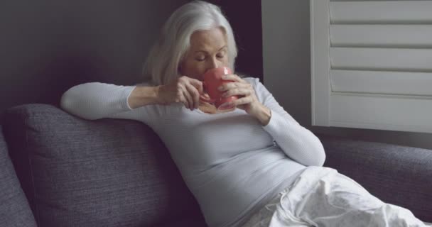 Vista Lateral Una Mujer Caucásica Superior Reflexiva Beber Café Sofá — Vídeos de Stock