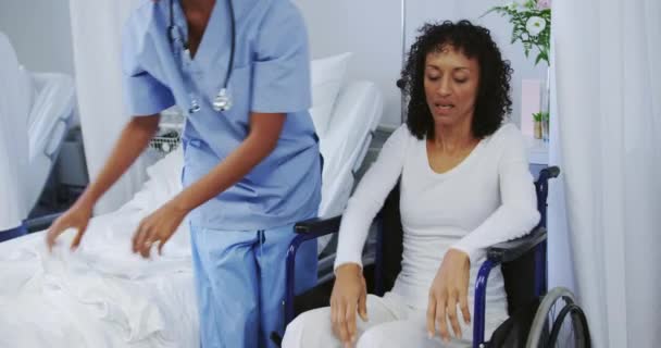 Front View African American Female Doctor Helping Disabled Female Patient — Stock Video