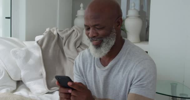 Evde Bir Akıllı Telefon Kullanarak Olgun Bir Karışık Yarış Adam — Stok video