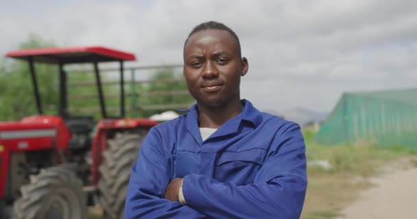 Retrato Joven Agricultor Afroamericano Una Granja Orgánica Parado Frente Tractor — Vídeos de Stock