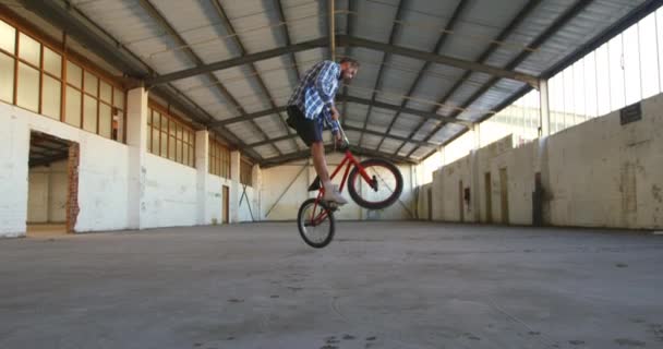 Sidoutsikt Över Ung Kaukasisk Man Hoppning Svarvning Och Balansering Bakhjulet — Stockvideo
