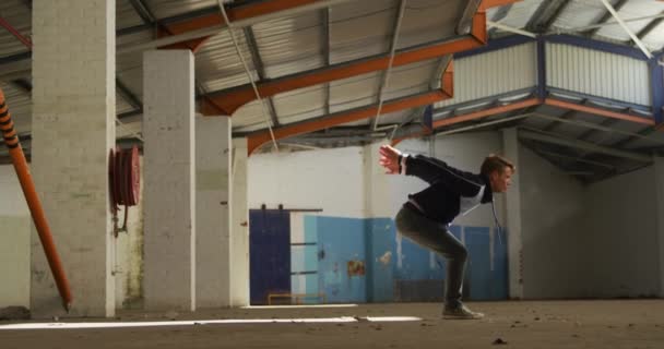 Side View Young Caucasian Man Doing Somersault Abandoned Warehouse — Stock Video