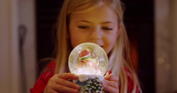 Front View Close Young Caucasian Girl Holding Snow Globe Sitting — Stock Video