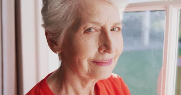 自宅で時間を過ごす高齢の白人女性の肖像 コロナウイルスの間に隔離されたロックダウンで自己分離Covid 19流行 カメラを見て スローモーション — ストック動画