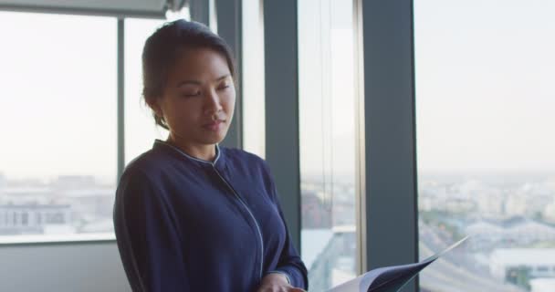 Przemyślana Azjatycka Profesjonalna Bizneswoman Pracująca Nowoczesnym Biurze Trzymająca Czytająca Magazyn — Wideo stockowe