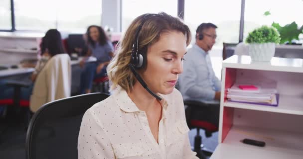 Caucasian Businesswomanat Office Creative Business Wearing Phone Headset Talking Slow — Stock Video