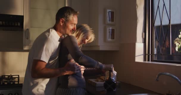 Caucasian Couple Home Standing Together Embracing Kitchen Morning Sun Front — 비디오