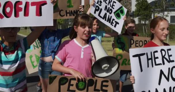 多族裔儿童群体慢吞吞地走在路上举行抗议游行 他们手持标语牌 标有环保和环保标语 小学生生态意识抗议 — 图库视频影像