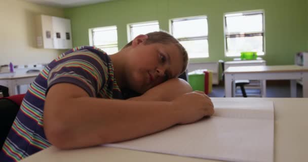 Белый Мальчик Сидит Опирается Стол Головой Руках Замедленной Съемке Образование — стоковое видео