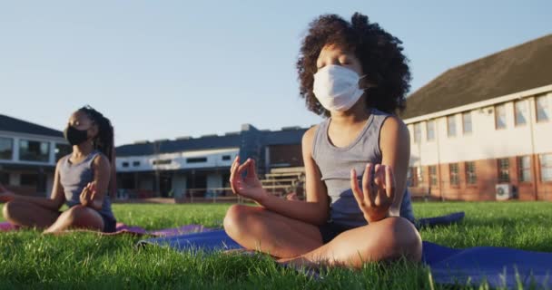 Mixed Race Girl Wearing Face Mask Meditating School Garden Primary — Stock Video