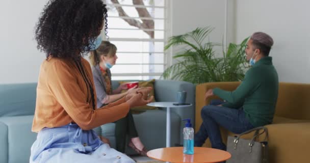 Mixed Race Female Creative Sitting Sofa Office Wearing Face Mask — Stock Video