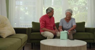 Kanepede oturan yaşlı, değişik bir çift. Memlekette, ultrason fotoğraflarına neşeyle bakıyorlar. Hamilelik, büyükanne ve büyükbaba, beklenti, aile, mutluluk, gelecek