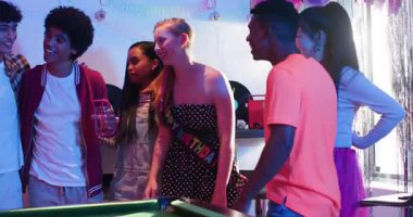 Doğum günü tebriklerine cevap olarak çeşitli arkadaşlar bilardo ıstakaları dağıtıp disko masasında tezahürat yapıyorlar. Kutlama, dostluk, gece hayatı, neon, retro, canlılık, takım çalışması