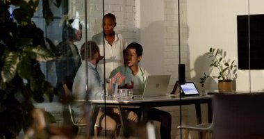 Modern ofiste bilgisayar ve tabletle iş birliği yapan çeşitli iş adamları. Takım çalışması, işbirliği, beyin fırtınası, teknoloji, dijital, çalışma alanı