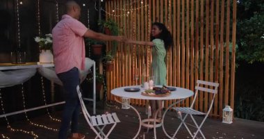 Romantik bir akşam, çeşitli çiftler terasta sicim ışıklarıyla sarılıyorlar. Aşk, gece hayatı, aşk, ilişkiler.