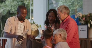 Çeşitli aileler evde kutlama yapıyor, kadeh kaldırıyor ve neşeli anları paylaşıyorlar. Kutlama, birliktelik, mutluluk, tost, bağ, şenlik