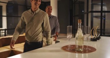 Ofis salonunda kutlama, çeşitli meslektaşlar şampanya kadehleriyle heyecanı paylaşıyorlar. Takım çalışması, işbirliği, kutlama, başarı, başarı, şirket