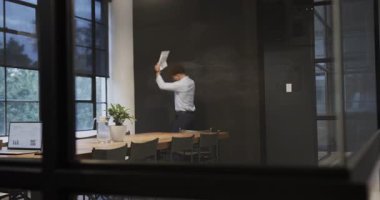 Çeşitli meslektaşlar modern ofiste başarıyı kutluyor, gülümsüyor ve heyecanlarını dile getiriyorlar. Takım çalışması, işbirliği, başarı, iş, çeşitlilik, neşe