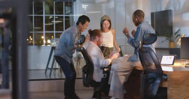 İş dünyası geceleri modern ofiste başarıyı kutluyor, heyecanlı hissediyorlar. Takım çalışması, kutlama, başarı, meslektaşlar, zafer, gece vakti