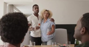 Çift bir arada, gülümsüyor ve yemek masasında kadeh kaldırıyor. Kutlama, mutluluk, çeşitlilik, birliktelik, aşk, yaşam tarzı