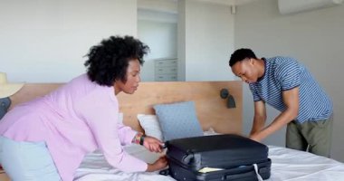 Genç çift modern yatak odasında şakacı etkileşim içinde, evde birlikte güzel vakit geçiriyorlar. Romantizm, samimiyet, ilişki, mutluluk, ev, bağ