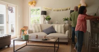 Evde doğum günü kutlaması için balonlarla ve afişlerle dekore edilen oturma odası. Parti, ev dekorasyonu, şenlik, hazırlık, neşeli